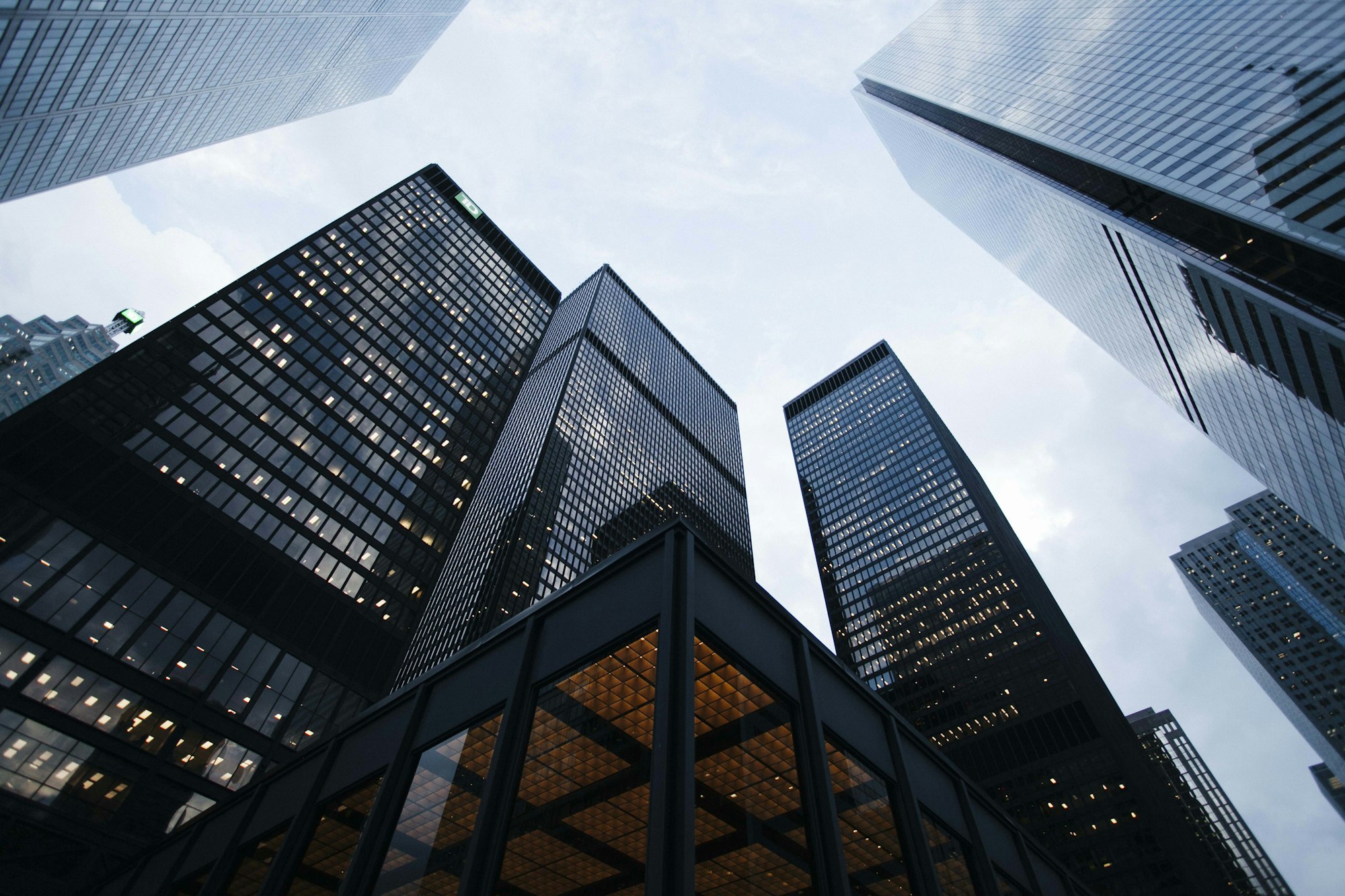 Glass commercial towers reflecting a pale sky